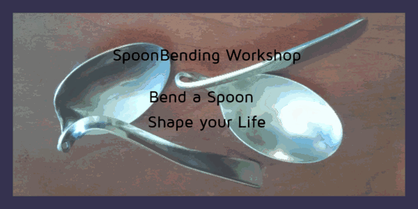 2 steel spoons twisted and bent on a tabletop